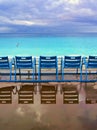 Blue chairs along the Promenade des Anglais on the Mediterranean Sea at Nice, France Royalty Free Stock Photo