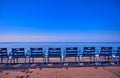 Blue chairs along the Promenade des Anglais on the Mediterranean Sea at Nice, France Royalty Free Stock Photo