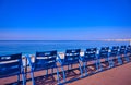 Blue chairs along the Promenade des Anglais on the Mediterranean Sea at Nice, France Royalty Free Stock Photo