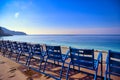 Blue chairs along the Promenade des Anglais on the Mediterranean Sea at Nice, France Royalty Free Stock Photo