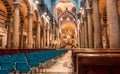 Blue chairs for prayers of the 11th century Roman Catholic cathedral with tall columns