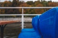 Blue chairs in raindrops on a pleasure boat in Moscow, autumn park in the background Royalty Free Stock Photo