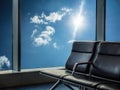 Blue chairs for sitting in the airport with blue sky and sunlight outside the window