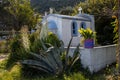 Blue chapel in a garden, Kinira, Greece