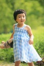 Blue checked skirt little girl holding teddy bear Royalty Free Stock Photo