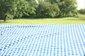 Blue checkered blanket on grass field natural background. Food advertisement display. Picnic cloth lying down outdoors Royalty Free Stock Photo