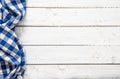 Blue checkered kitchen tablecloth on wooden table