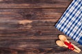 Blue checkered tablecloth on the black wooden table with copy space for your text. Top view Royalty Free Stock Photo