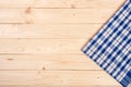 Blue checkered tablecloth on a light wooden table with copy space for your text. Top view Royalty Free Stock Photo