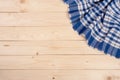 blue checkered tablecloth on a light wooden table with copy space for your text. Top view Royalty Free Stock Photo