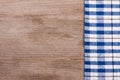 Blue checkered tablecloth on old wooden table with copy space for your text. Top view Royalty Free Stock Photo