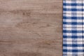 Blue checkered tablecloth on an old wooden table with copy space for your text. Top view Royalty Free Stock Photo