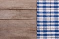 Blue checkered tablecloth on an old wooden table with copy space for your text. Top view Royalty Free Stock Photo