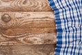 Blue checkered tablecloth on the old wooden table with copy space for your text. Top view Royalty Free Stock Photo