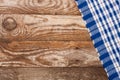 Blue checkered tablecloth on the old wooden table with copy space for your text. Top view Royalty Free Stock Photo