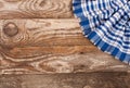 Blue checkered tablecloth on the old wooden table with copy space for your text. Top view Royalty Free Stock Photo