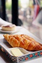 Blue cheese croissant served with butter. A restaurant scene for background with copy space.