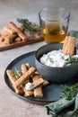 Blue cheese dressing or dip sauce with rosemary and gingerbread cookies sticks on concrete background