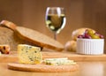 Blue cheese with glass of wine on a background Royalty Free Stock Photo