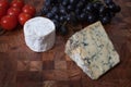 Blue cheese, goats cheese, tomatoes and sable grapes Royalty Free Stock Photo