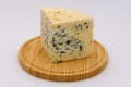 Blue cheese on a simple wooden plate Royalty Free Stock Photo