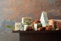 Blue cheese with walnuts, bread and rosemary on a rusty table Royalty Free Stock Photo