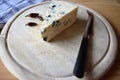 Blue cheese on wooden board.