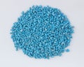 Blue chemical fertilizer on white background.