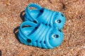 Blue children's sneakers on the beach Royalty Free Stock Photo