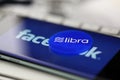 Blue chip with libra sign lying on smartphone display