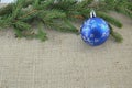 Blue Chirstmas ornament and a pine tree