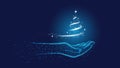 Blue Christmas background. Christ`S Birth. Star of Bethlehem, snowstorm in the shape of a Christmas tree in a polygonal hand Royalty Free Stock Photo