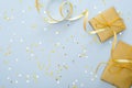 Blue Christmas background with golden gifts box, ribbon, glitter confetti stars. Christmas, New Year, winter holidays and birthday