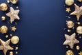 Blue Christmas background with golden stars, baubles, confetti. Frame border of luxury Christmas decorations. New Year greeting Royalty Free Stock Photo