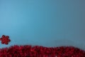 Blue Christmas background with red glittery snowflake decoration and red garland. Top view with copy space Christmas composition Royalty Free Stock Photo