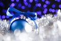 Blue christmas ball and blured purple lights at the background Royalty Free Stock Photo