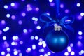 Blue christmas ball and blured purple lights at the background Royalty Free Stock Photo