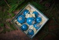 Blue Christmas balls in the boxes. Wooden background.