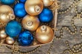 Blue Christmas balls and gold, beads lie in a wooden basket top Royalty Free Stock Photo
