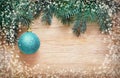 Blue Christmas balls hanging on fir branch in snow