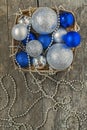 Blue Christmas balls and silver, beads lie in a wooden basket to Royalty Free Stock Photo