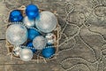 blue Christmas balls and silver, beads lie in a wooden basket to Royalty Free Stock Photo