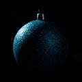 Blue Christmas bauble over dark background. Low key photo. Ball shape. Royalty Free Stock Photo