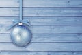 Blue Christmas baubles with curly ribbon on a blue wooden board with copy space. Simple Christmas card