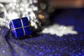 Blue Christmas gift for tree, snowflakes and blue shimmering background Royalty Free Stock Photo