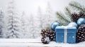 Blue Christmas gift with white ribbon, balls pine cones and spruce branches. Royalty Free Stock Photo