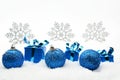 Blue christmas gifts and baubles with snowflakes on snow Royalty Free Stock Photo