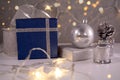 Blue christmas gifts  silver decoration ball  ribbon  cone  drum and golden lights Royalty Free Stock Photo