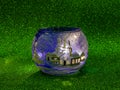 Blue Christmas house and snow pot with bright green background Royalty Free Stock Photo