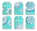 Blue Christmas labels with origami white snowflake.